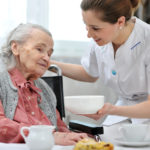 Senior,Woman,Eats,Lunch,At,Retirement,Home
