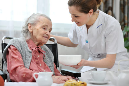 Senior,Woman,Eats,Lunch,At,Retirement,Home